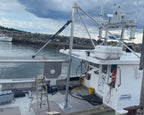 Boat docked at a pier with a cloudy sky