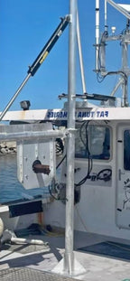 Fishing boat with equipment on a dock under a clear blue sky