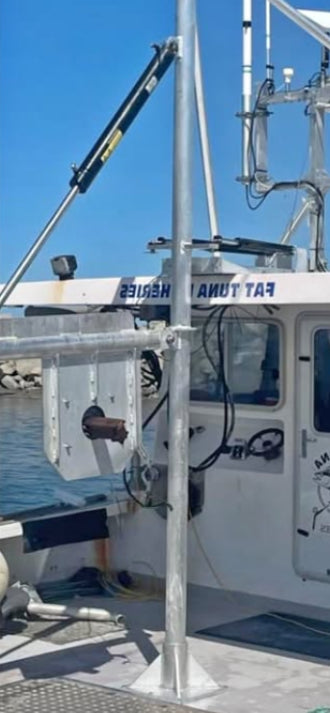 Fishing boat with equipment on a dock under a clear blue sky