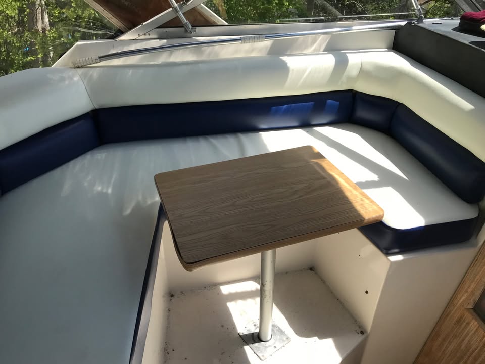 Wooden table on a boat with white and blue interior