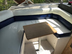 Wooden table on a boat with white and blue interior