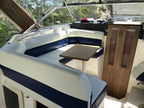 Interior of a boat with seating area and wooden cabinet