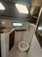 Bathroom interior of a boat with toilet and sink.