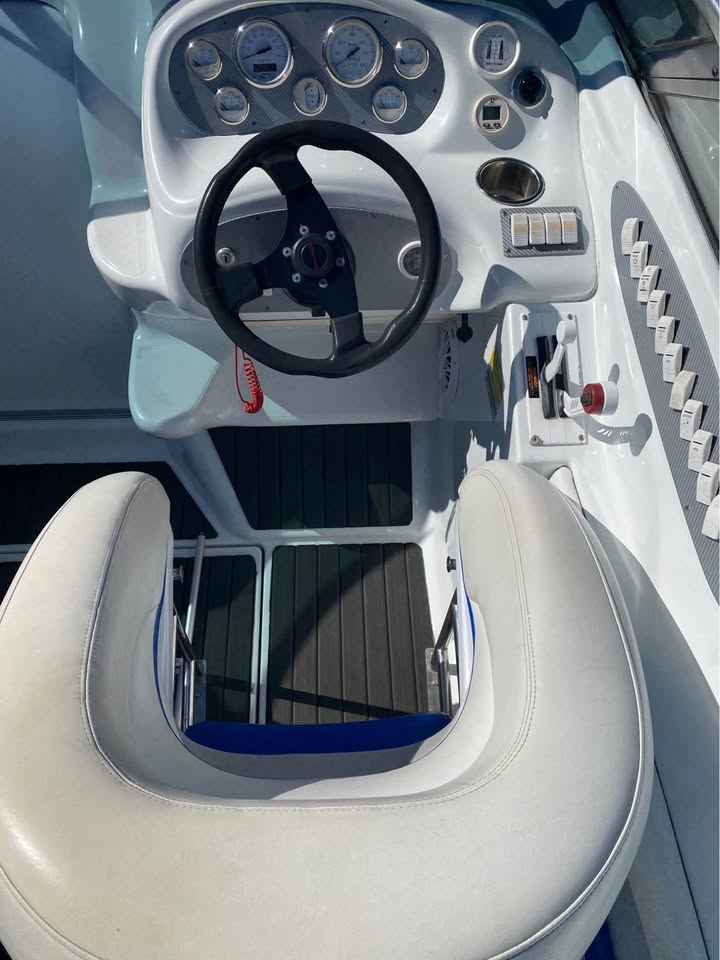 Speedboat on a body of water with a cloudy sky