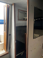 Interior of a vehicle with a door open, showing a mirror and part of the interior.