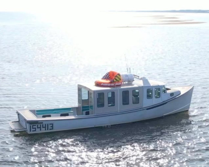 White boat with a red lifeboat on a calm body of water