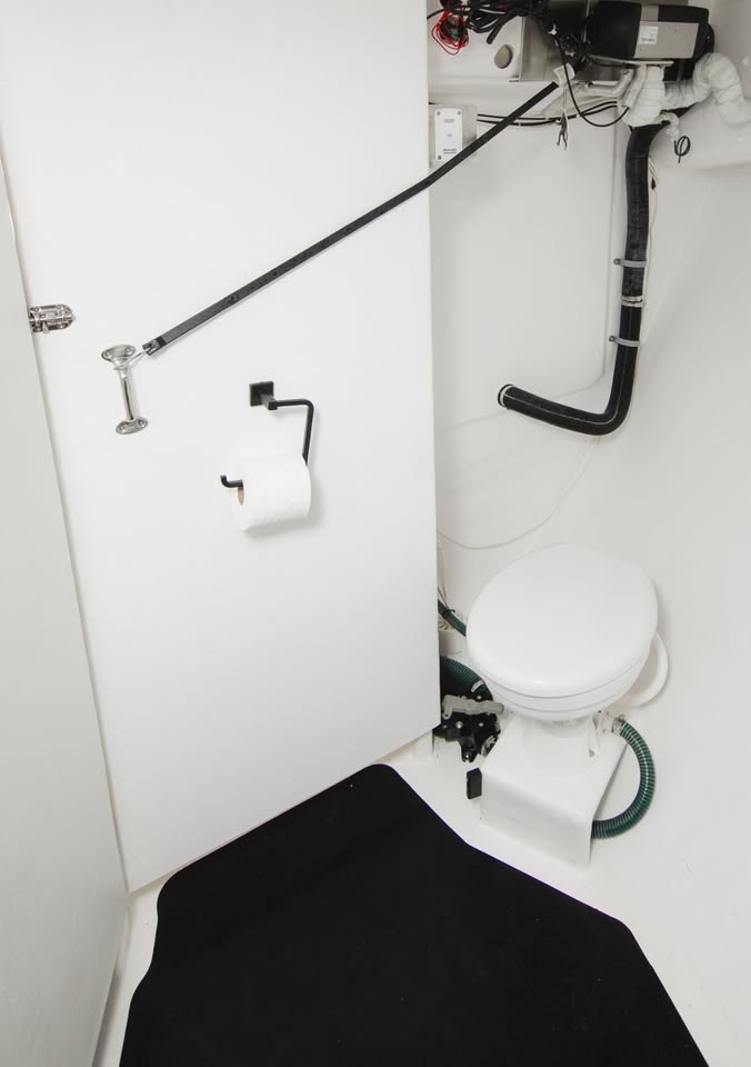 Compact bathroom with a toilet and shower setup in a small space