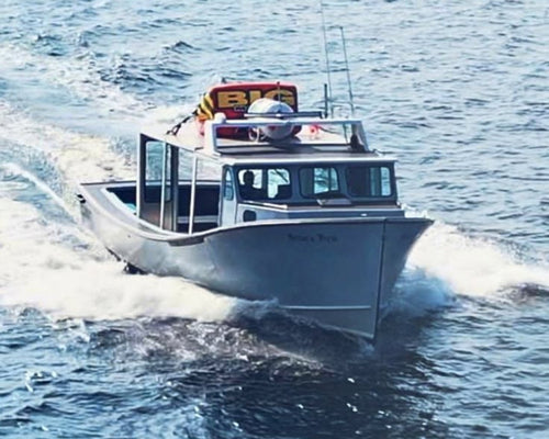 White boat with a cabin cruising on a body of water