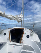 Sailboat on water with open cabin door