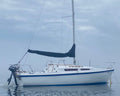 Sailing boat on calm water with a cloudy sky