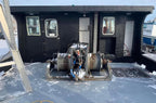 Mechanical winch on a boat with a black cabin in the background