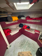 Bunk beds with bedding in a small enclosed space