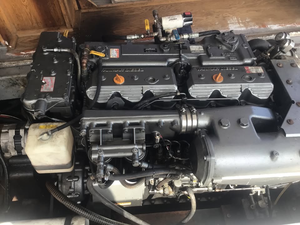 A large industrial marine engine with prominent 'JUMBO' and 'NATIONAL DIESEL' branding on the intake covers, photographed in a workshop or storage setting.