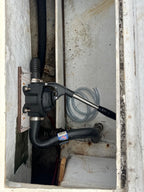 Pump and hoses inside a metal compartment