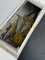 Close-up of a mechanical component with yellow cables inside a metallic box.