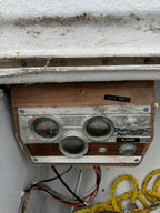Vintage-style electronic device with wooden casing on a concrete surface