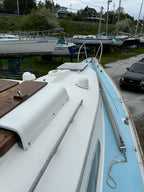Close-up of a boat's bow with a marina background