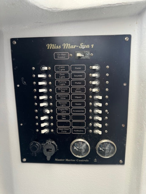 A vintage black marine electrical switch panel labeled 'Miss Mar-Spa 1' and 'Master Marine Controls', mounted on a white wall.