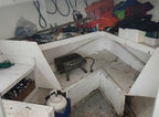 Messy workshop with tools and equipment on a workbench
