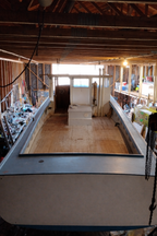 Basement with unfinished walls and floor, showing construction or renovation work.