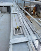 A close-up view of a metal walkway or industrial platform with diamond-plate flooring, railings, and fastened beams, shown within a phone app screenshot.