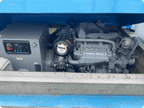 A Kohles marine diesel engine and alternator unit installed inside a blue generator enclosure, with the engine bayonet visible and the alternator on the right side.